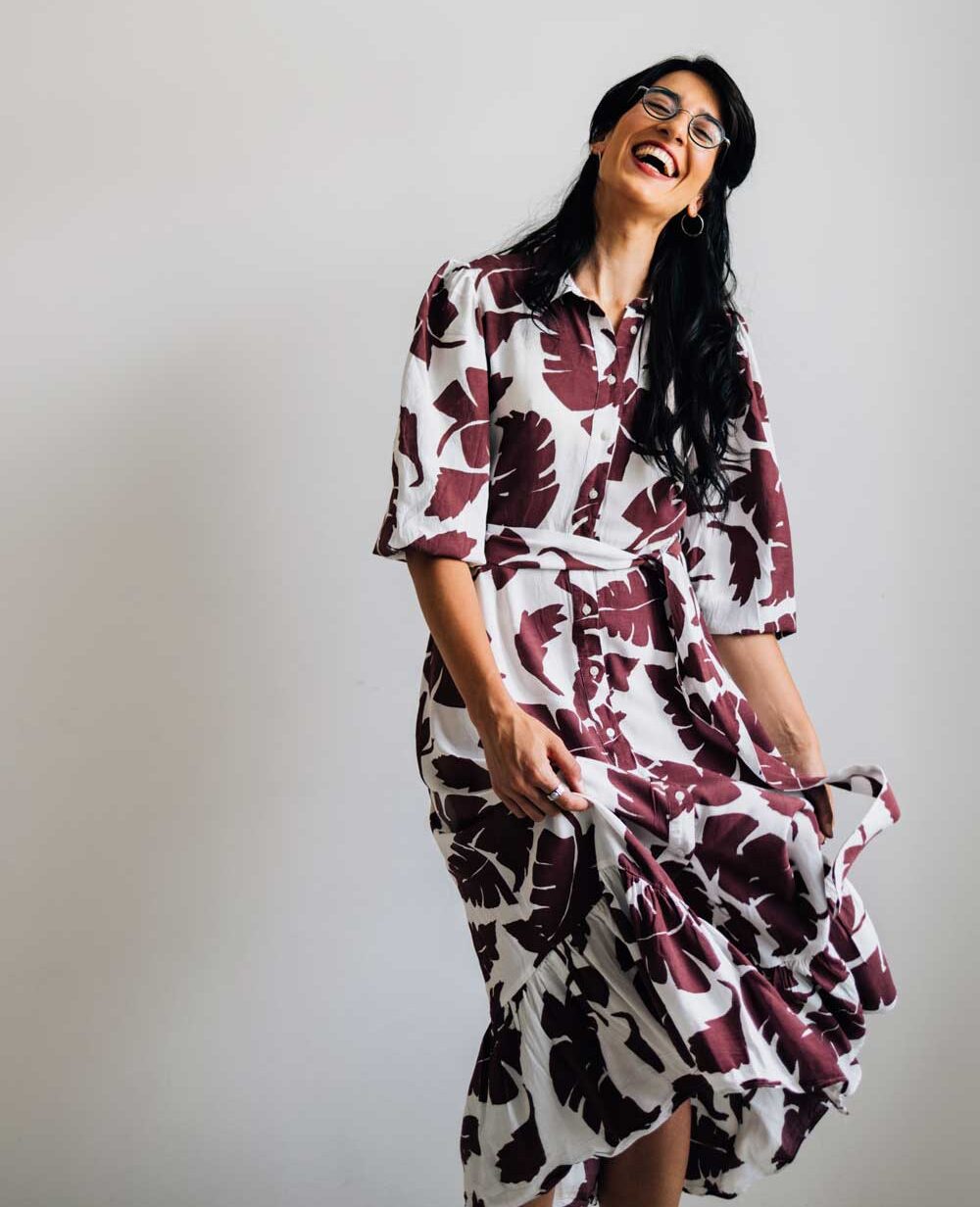 Awakened school participants support photo of happy woman feeling confident in patterned dress